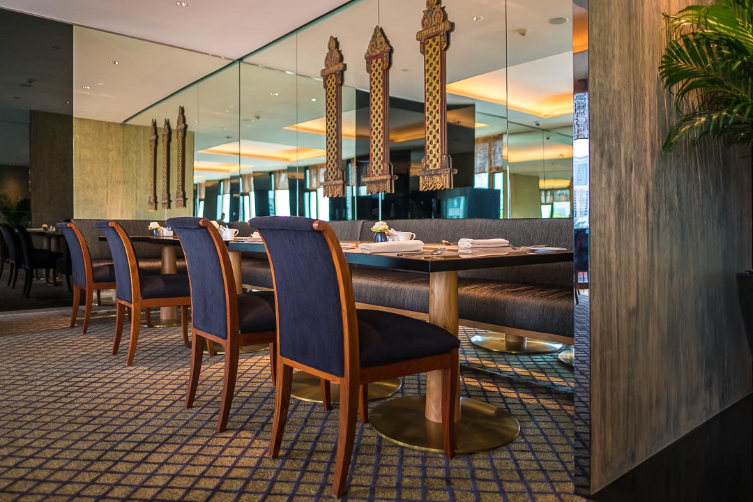 https://hungryformore.be/app/uploads/2024/12/sukhothai-bangkok-restaurant-with-blue-chairs.jpg