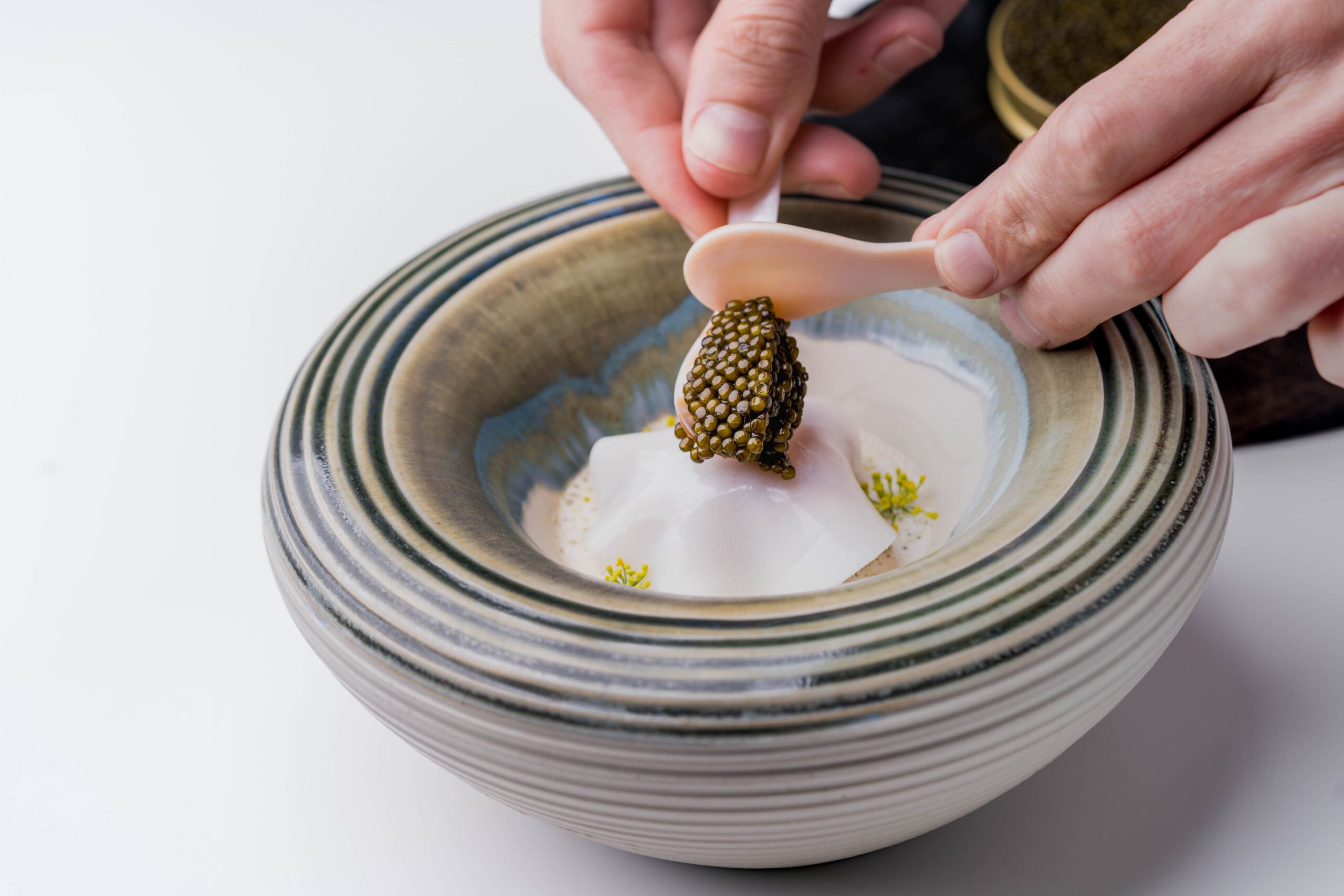 Caviar being spooned onto a dish at restaurant Vintage in Kontich