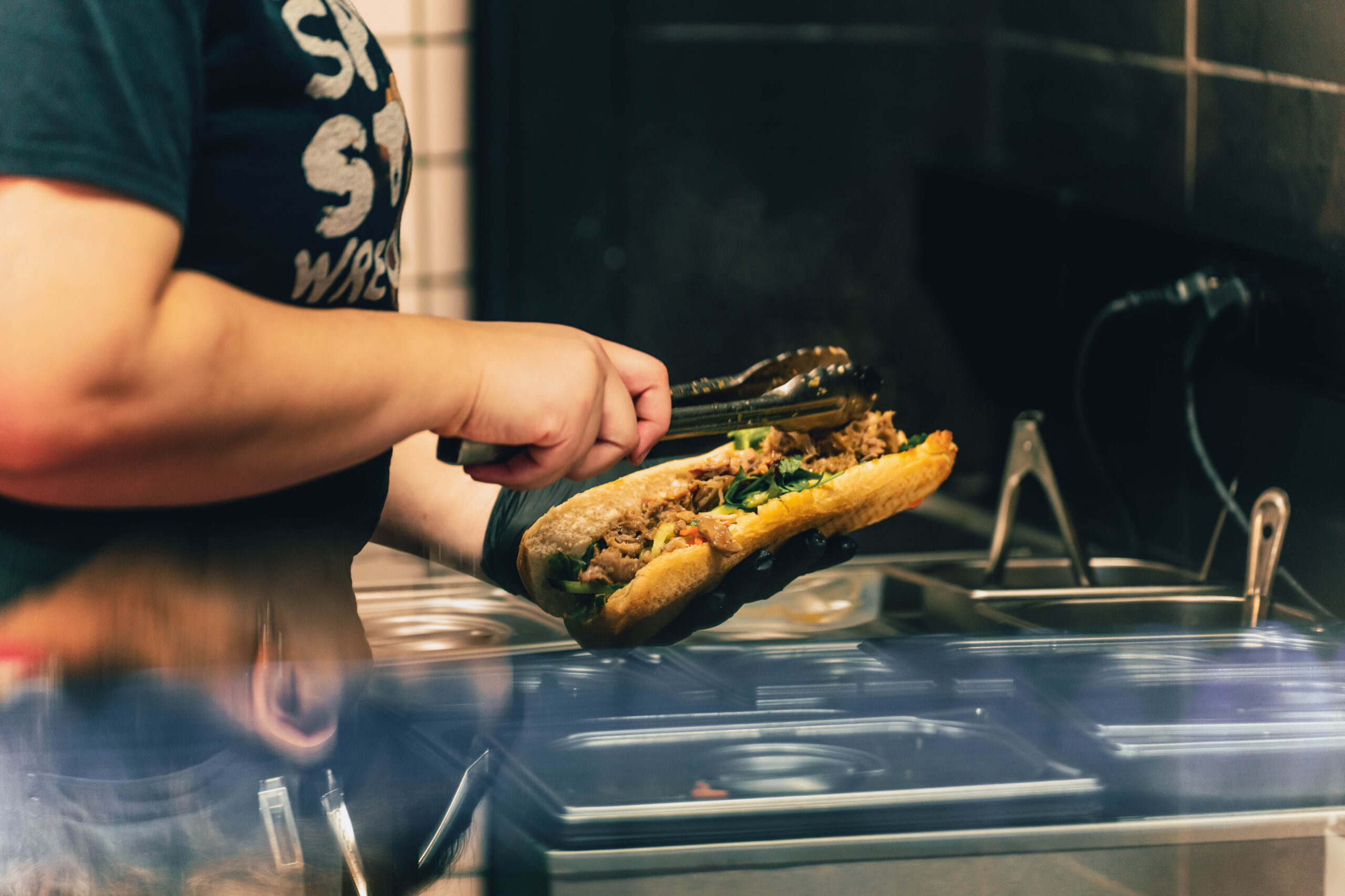 https://hungryformore.be/app/uploads/2026/10/banh-mi-express-baguette-filling-preparation-scaled.jpg