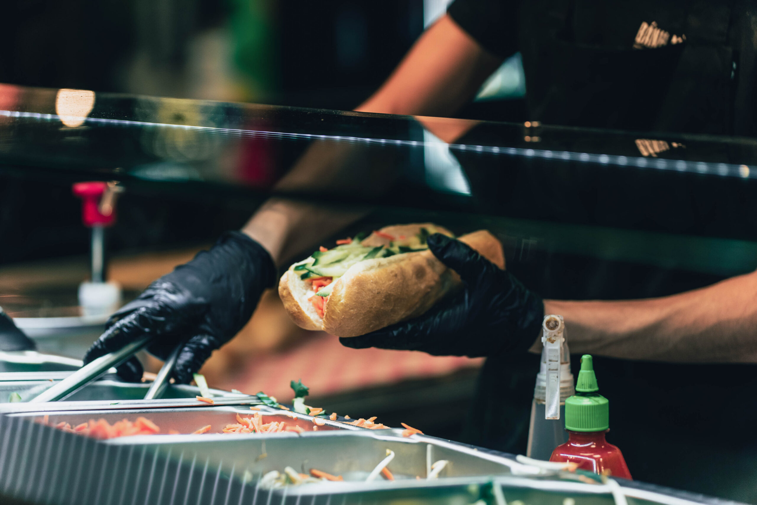 https://hungryformore.be/app/uploads/2026/10/banh-mi-express-banh-mi-preparation-counter-scaled.jpg